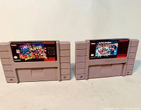 Photo showing front view of two SNES cartridges: Tetris & Dr. Mario on the left, Super Mario All-Stars on the right.