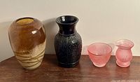 Photo of amber Murano style vase and LE Smith black amethyst vase on table.