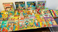Photo showing a large collection of various Berenstain Bears vintage softcover books laid out on a surface, visible titles include 'No Girls Allowed', 'Trick or Treat', 'In the Dark', and 'Too Much TV'.