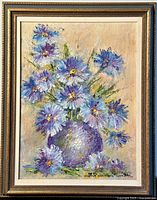 Front view of original oil painting depicting purple flowers in a vase, framed.