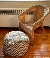 Wicker armchair with cushion footstool on wooden floor near radiator.