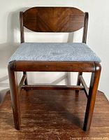 Front view of vintage walnut wood vanity seat with cushioned seat and wooden backrest