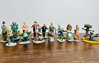 Wide shot of all figurines arranged on a wood surface