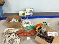 Overview of cords, electrical parts and new lighting fixtures arranged on floor