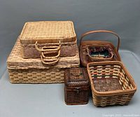 Group photo of six woven baskets of various sizes, shapes, and styles arranged together.