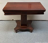 Front view of the square wooden Empire game table, showing the top and pedestal base.