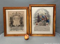 Front view of two framed Masonic lithograph prints side by side with apple for scale.