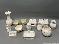 Full collection of Belleek porcelain items with distinctive shamrock green decoration.