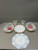 Full lot showing two opalescent bowls, two vases, and two plates arranged on a gray surface.