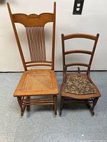 Two wooden rocking chairs side by side, one taller with rattan seat and one smaller with upholstered seat.