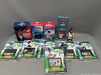 Photo showing boxed figurines of baseball players Max Scherzer, Bryce Harper, Adam Eaton in front, and 7 Heritage XP trading card packs laid out.