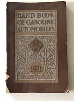 Front cover of 1911 Hand Book of Gasoline Automobiles, showing ornate design and visible wear with spine damage