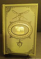 Front cover of antique book showing gold oval illustration of horse and foal with decorative embossing.