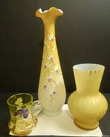 Photo showing all three items together: the tall amber/peach vase with floral enamel design, the bulbous bubble-patterned vase, and the small decorated cup.