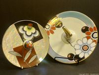 Side-by-side Noritake decorative plates showing different designs and sizes with metallic trims