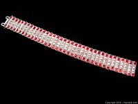 Full view of bracelet laid flat on black background showing entire length and design