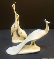 Front angled view showing both porcelain bird figurines on black background for size and detail reference