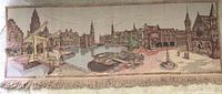 Full view of vintage Dutch tapestry showing continuous panoramic cityscape with canals, boats, historic buildings, and a fountain with people, including bottom fringe.