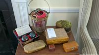 View of full lot showing several decorative boxes, Chinese exercise balls in original box, a small treasure chest, a glass-faced potpourri container, and a basket with fabric inside.