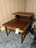 Full view of the wooden step back side table showing the two-tier construction, tapered legs, and natural wood finish.