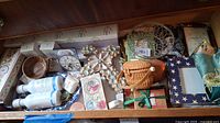 Top view of wooden drawer with wrapped soaps, trays, basket, and boxes