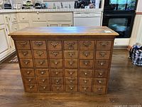 Front view showing 30 drawers with label holders and pulls