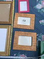 Assorted frames including large gold frame, red frame, two engraved wood frames