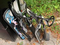 Overall view of two GT Snowracer sleds stacked beside two snowboards
