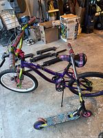 Photo of the Monster High BMX style bicycle and Monster High scooter in garage