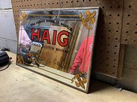 Photo of the Haig Blended Scotch Whisky mirror reflecting surroundings, showing decorative border and text.