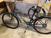 Full side profile of the green CCM Villager bike showing frame, seat, tires, and rear rack.