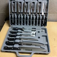 Full view of 12 piece Schinken Messer cutting set in molded plastic case showing knives and forks.