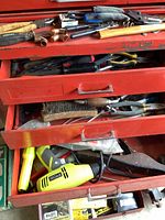 Open middle and lower drawers showing wire brush, pliers, putty knife and Ryobi heat gun