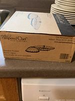 Box of the Pampered Chef Stainless Steel Steamer showing brand, product name, and product details.