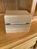 Closed light wooden recipe box with smooth natural finish and horizontal slot opening on front