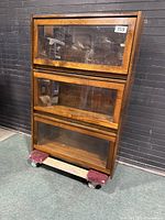 Front view of 3-tier wooden barrister bookcase with glass panel doors stacked vertically.