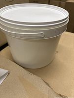 Photo of single white plastic bucket without lid, showing bucket shape and handle.