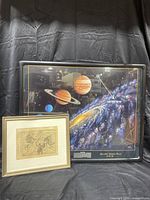 Two framed constellation art prints, one large solar system depiction with Milky Way and one smaller vintage-style constellation map with frame and matte.