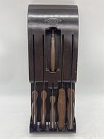 Front view of CUTCO knives stored upright in the organizer showing wooden handles and blade shapes