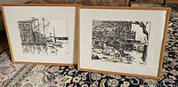 Front view of two framed art prints, one with a harbor scene with boats and buildings, the other with rustic outdoor scene. Both signed J.H. Sharp and framed with white matting and wood frames.