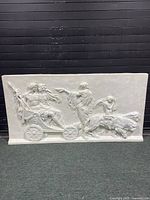 Full front view of the large rectangular hanging wall sculpture showing all the figures and chariot details.