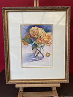 Full view of framed watercolor painting of yellow roses in glass vase by Jo-Ann Osnoe