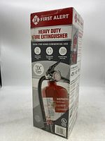 Front side of the unopened box showing extinguisher image and key features like 3X fire fighting capacity and ideal for home/commercial use.