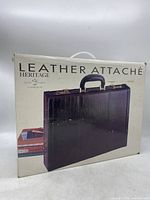 Front view of packaging showing the Heritage Leather Attaché briefcase image and branding
