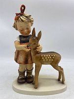Front view of the Goebel Hummel figurine showing girl feeding deer