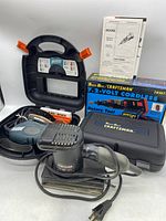 Sears Craftsman finishing sander, Black & Decker Mouse sander in front, Sears Best Craftsman 7.2V cordless rotary tool box and case in background, tools arranged with manuals.
