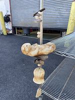 Front wide angle view showing the full hanging wind chime including sea otter, bird, shells, bell, and leaf elements.