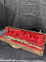 Vintage clarinet in an old case with red plush lining.