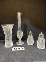Photo showing the full set of two vases and pair of salt and pepper shakers with diamond cut crystal design.