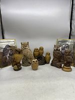 Group showing entire owl figurine collection and framed pictures